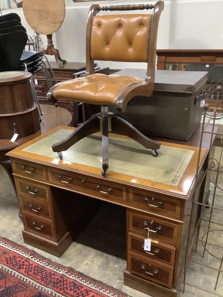 A reproduction inlaid mahogany pedestal desk, width 122cm, depth 61cm, height 80cm together with a mahogany swivel desk chair